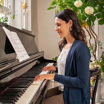a woman with instant access premium membership playing piano