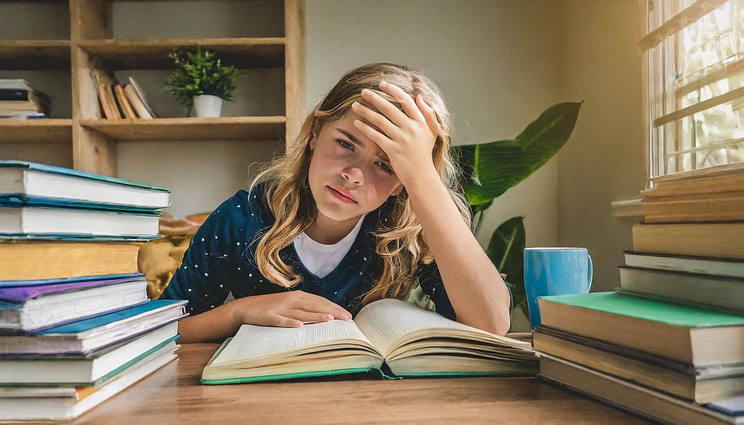 A frustrated young girl wondering if learning music theory is necessary for piano