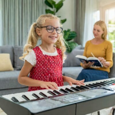 A chid learning piano by taking painless piano lessons for beginners.