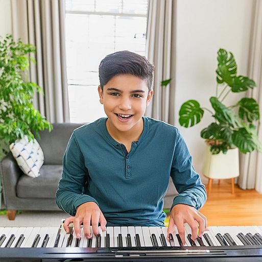 a boy taking painless piano lessons for beginners with Jackie Clark