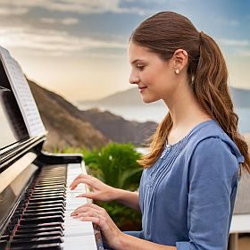 young lady learning to play the piano with beginners piano lessons